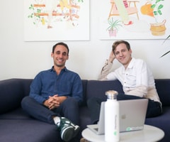 Headway’s co-founders sitting on a couch in the office