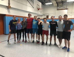 A Headway team lined up in a gym after a dodgeball game