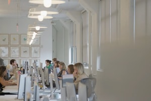 Headway employees working at long desks in the New York office